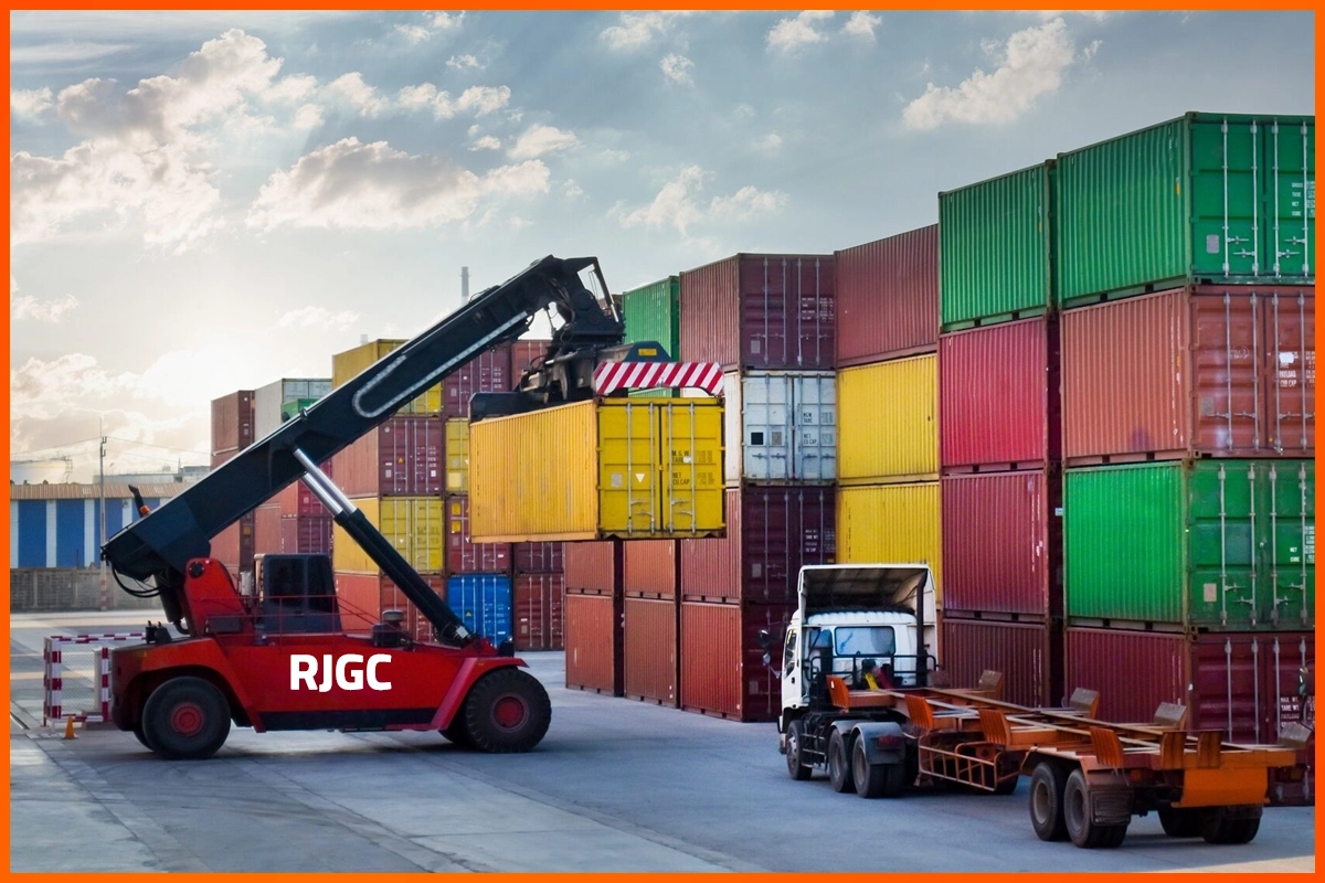 Reach stacker lifting a container at a busy terminal